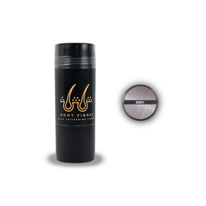 Front view of Root Fibres hair thickening fibres in a stylish black bottle with a prominent gold logo. The white and gold caption states 'Root Fibres Hair Thickening Fibres – Professional, Quality, Confident.' Additionally, the image includes a top view of the bottle with a Grey hair colour indicator featuring a picture of Grey hair and the caption 'Grey.' This product effectively conceals thinning hair, providing a natural and voluminous look.